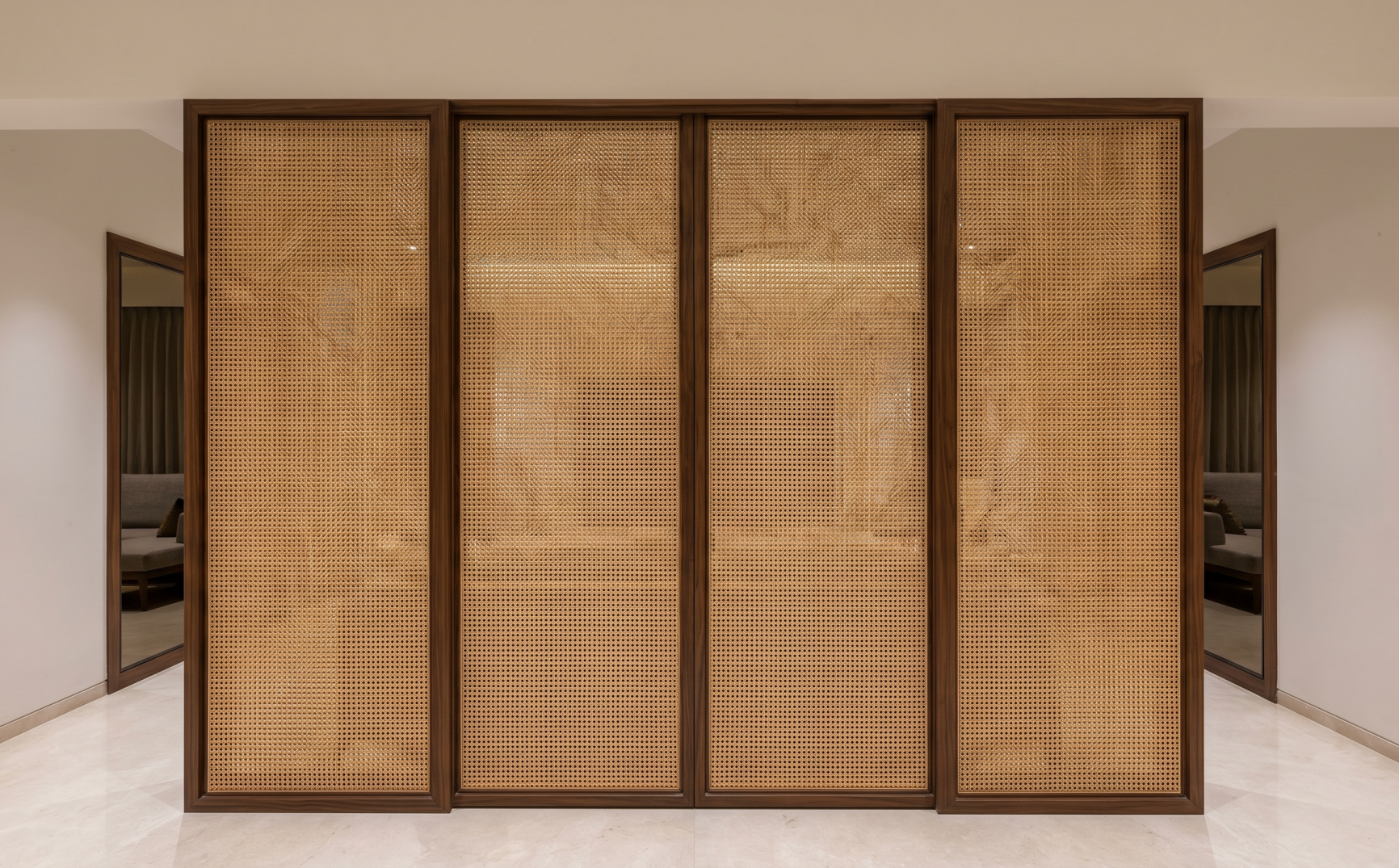 Flawless natural rattan webbing installed on dark wood wardrobe doors in a modern luxury home.